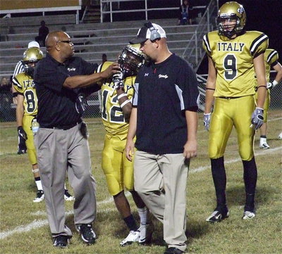 Image: Gladiator assistant coach Larry Mayberry, Sr., and head coach Hank Hollywood check on Eric Carson(12) who exited the game briefly after being injured.