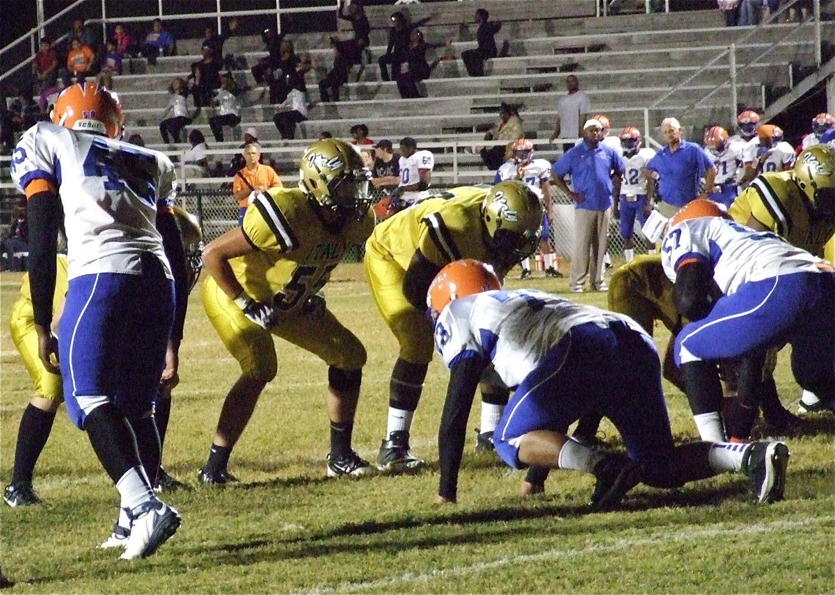 Image: Senior lineman Zackery Boykin(55) and Adrian Reed(64) prepare to block during an extra-point kick.