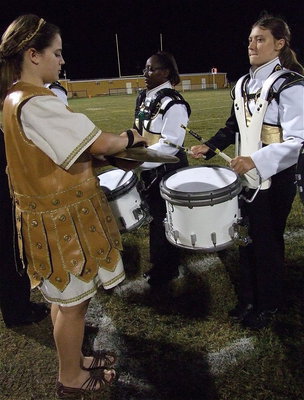 Image: Reagan Adams, Brenya WIlliams and Whitney Wolaver do work on the drum line.