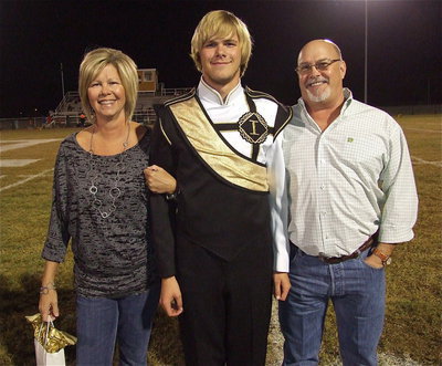 Image: Senior band member and drum line captain Gus Allen is escorted by his parents, Brian and Leslie Allen. After high school, Gus hopes to continue acting while pursuing a career in law enforcement.