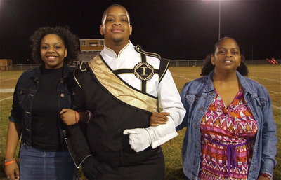 Image: Senior band member Timothy Maurice Fleming, Jr., is escorted by his sister Jaleecia Fleming and his mother Jacqueline Fleming. Timothy’s favorite band memory is when the football team charged out of the tunnel to Tim playing his song.