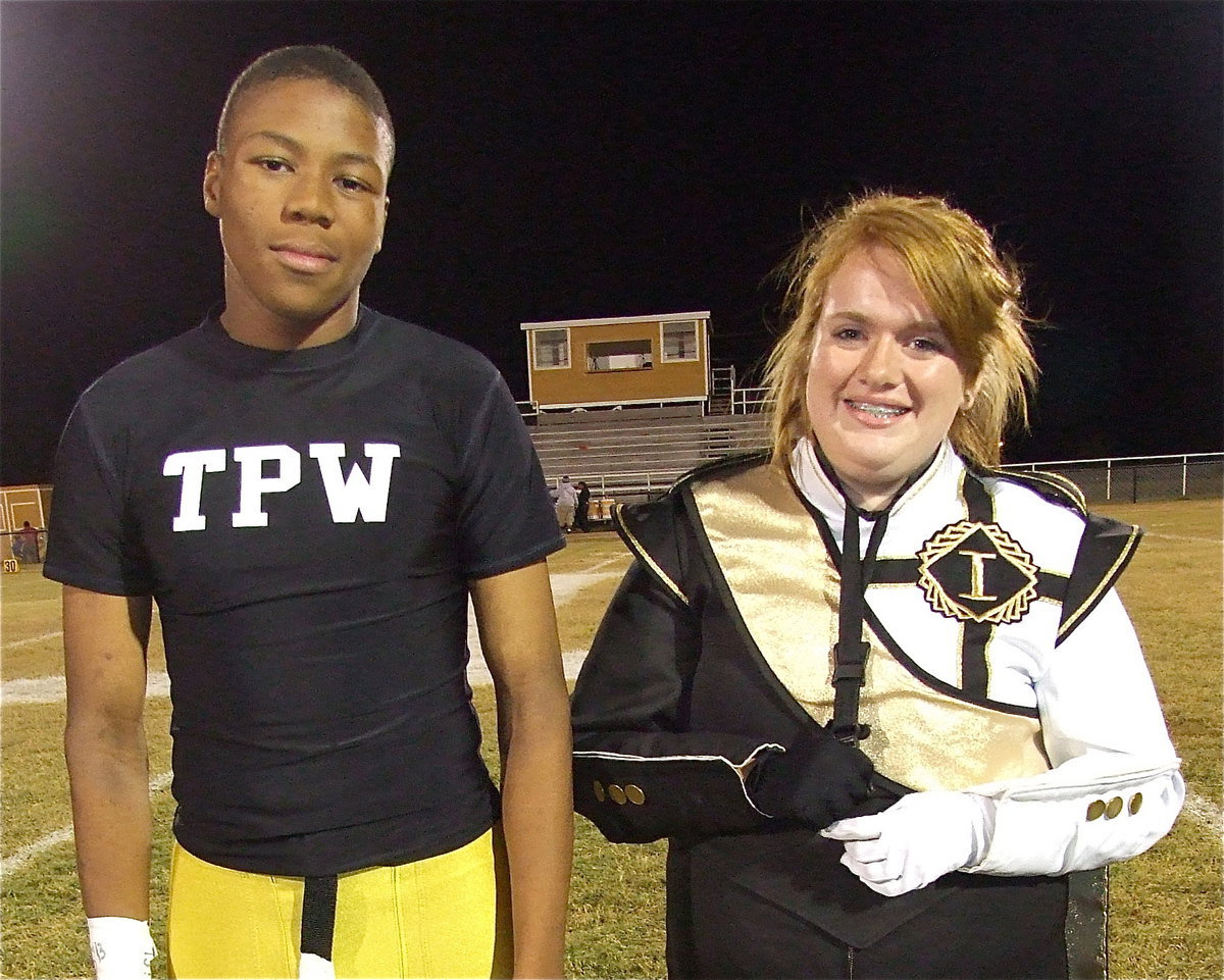 Image: Senior band member John “Squirt” Hughes is escorted by drum major and friend Emily Stiles. Squirt plans to attend LSU after graduation.