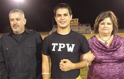 Image: Senior band member Reid Jacinto is escorted by father Mark Jacinto and his mother Susan Jacinto. After graduation, Reid plans on attending the University of Texas at Austin to major in business.