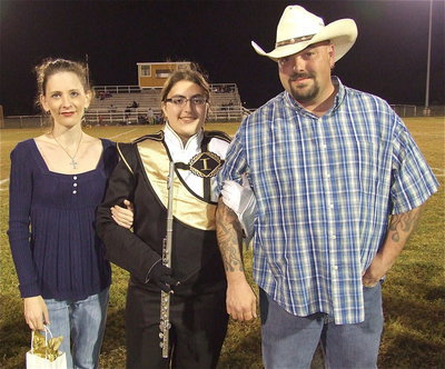 Image: Senior band member Morgan Junkin is escorted by her parents Charlotte Kemp and Brent Junkin. Morgan plans to attend the Art Institute in Dallas to become a self-employed artist.