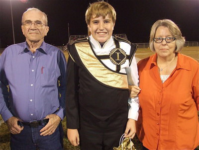 Image: Senior band member Brett Kirton is escorted by his parents, Lyall and Alyssa Kirton. After graduation, Brett plans on attending the University of Texas at Austin.