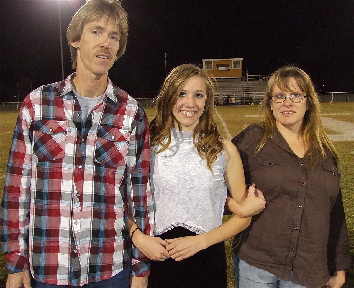 Image: Senior color guard member Brooke Miller is escorted by her parents, Jennifer Merimon and Timmy Miller. Brooke plans to be a professional photographer.