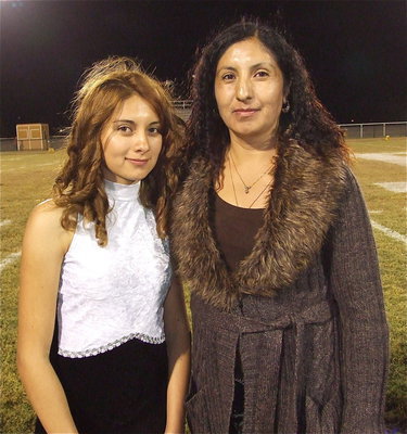 Image: Senior color guard member Maria Patino is escorted by her mother Uriel Patino. Despite only being in the color guard one year, Maria appreciates everyone who helped her during her wonderful experience.