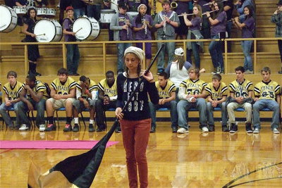 Image: Color guard member Maria Patino performs a routine during the pep rally as the band plays and as the football players embrace their school’s spirit.