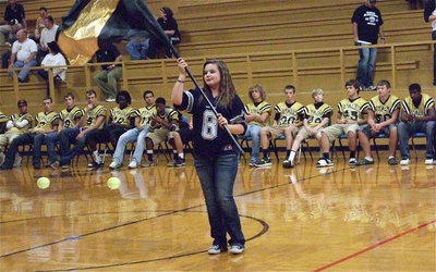 Image: Color guard member Alexis Burchett executes a routine during the pep rally.
