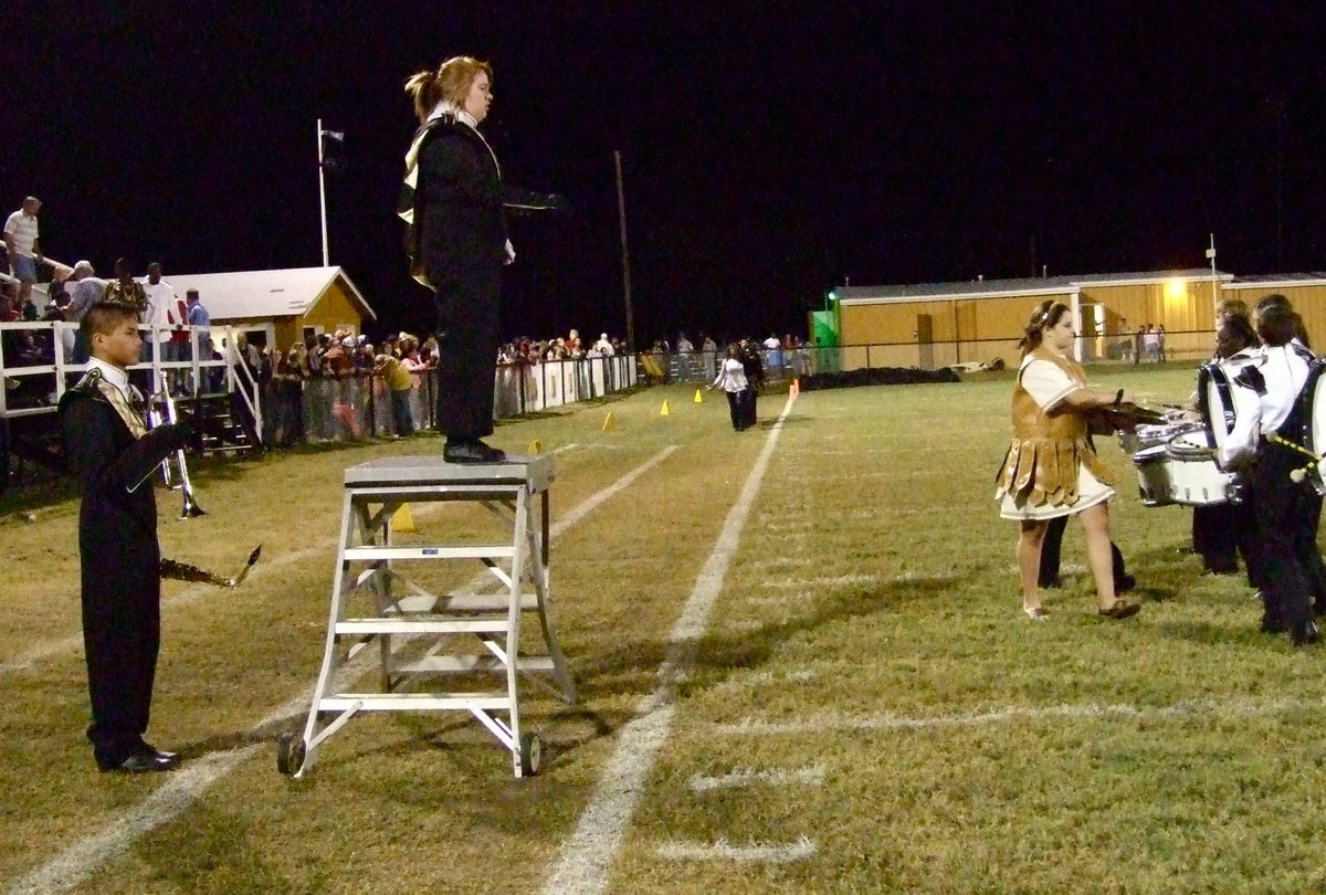 Image: Drum Major Emily Stiles guides the band through their paces on the field during halftime.