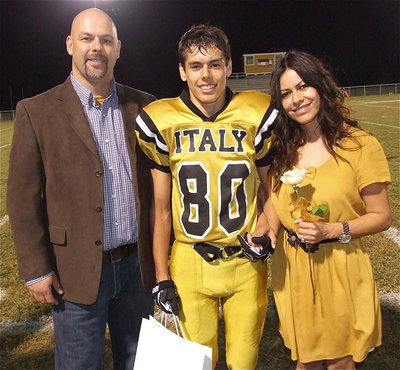 Image: Senior Gladiator Kelvin Joffre(80) is escorted by his parents Lee Joffre and Gabrielle Apa. Kelvin plans to attend the University of Texas at El Paso and become an engineer. Kelvin’s most memorable moments in athletics are hanging out with friends before each game.