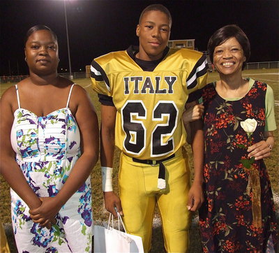 Image: Senior Gladiator John “Squirt” Hughes(62) is escorted by Tanya Jennings and his mom Judy Hughes. John’s hobbies and interests are playing video games and hanging out with friends. His most memorable moment in athletics was watching Marvin Cox’s helmet fly off between first and second during a baseball game.