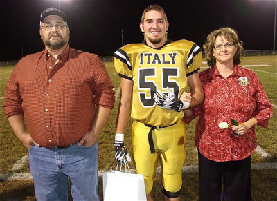 Image: Senior Gladiator Zackery Boykin(55) is escorted by his parents Kelly and Sally Arthur. Zack plans to attend Navarro College for EMT school and become a Dallas Firefighter. His most memorable moment in athletics was as a sophomore during the Red Oak Life football game when he destroyed the punter. Ironically, but sadly, the punter was a girl.