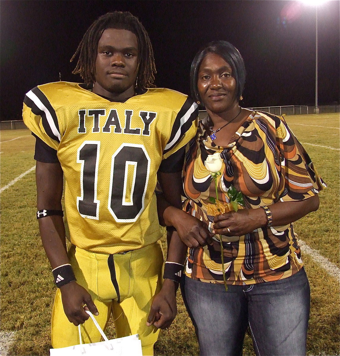 Image: Senior Gladiator Ryheem Walker(10) is escorted by his mother Belinda Walker. His goals after graduation are to attend the University of North Texas at Denton and become a college football player. His most memorable moment in athletics was going out to eat with teammates before each game.