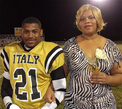 Image: Senior Gladiator Jalarnce Jamal Lewis(21) is escorted by his mother Lavinia Smith. Jamal will attend a junior college in Georgia to play football and hopefully become an NFL football player. His most memorable moment in athletics was when he and his Gladiator teammates came together and played for each other in the Cayuga game, in which Italy won 20-16.
