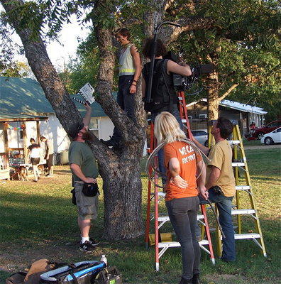 Image: Brenden, the lead male of the short film, prepares to shoot a scene while in a tree.