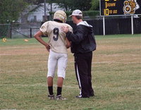 Image: IJH quarterback Devonteh Williams(9) gets play instructions from coach Josh Ward.