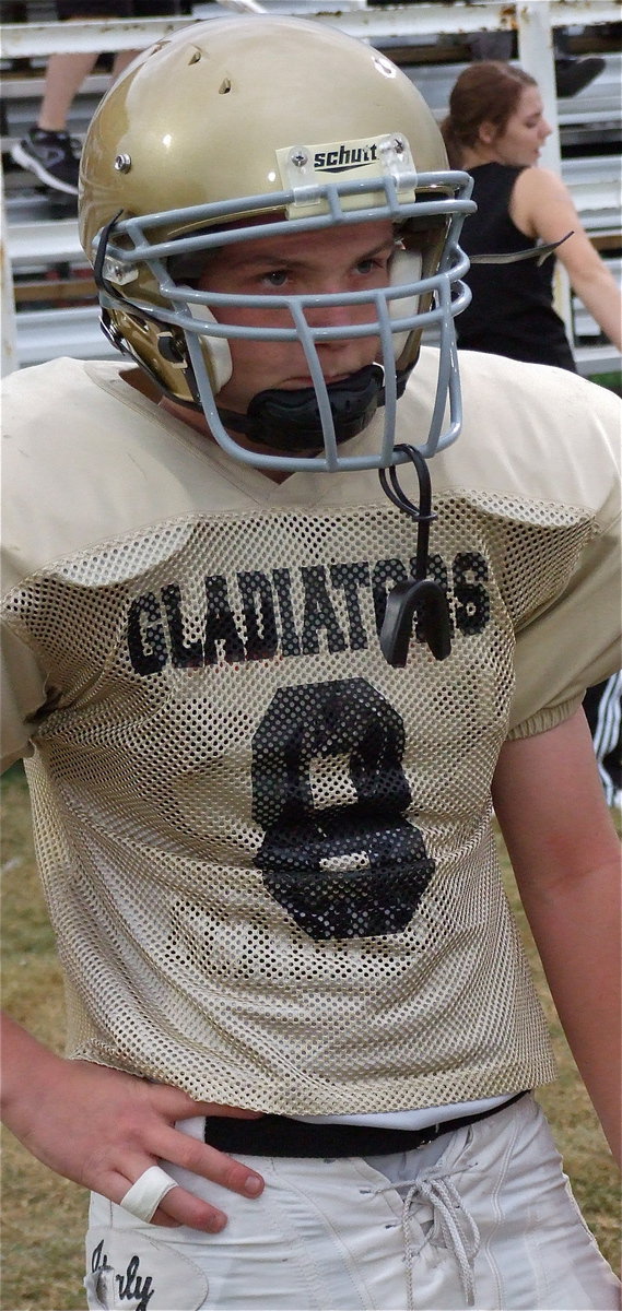 Image: Devon Bowles(8) is taped up, buckled up and on a mission against Cayuga.