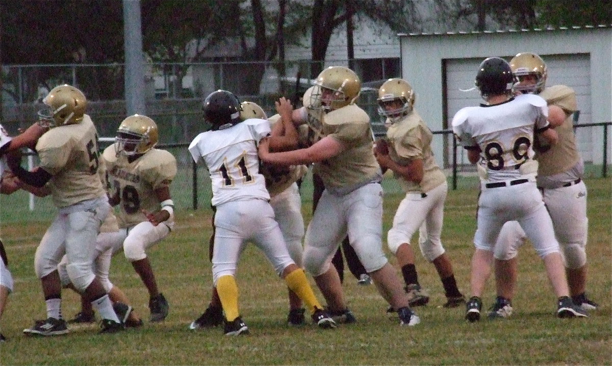 Image: Devonteh Williams(9) drops back into the pocket with Kenneth Norwood, Jr.(54), Jarvis Harris(89), David De La Hoya(55), Austin Pittmon(51) and Aaron Pittmon(50) protecting their quarterback.