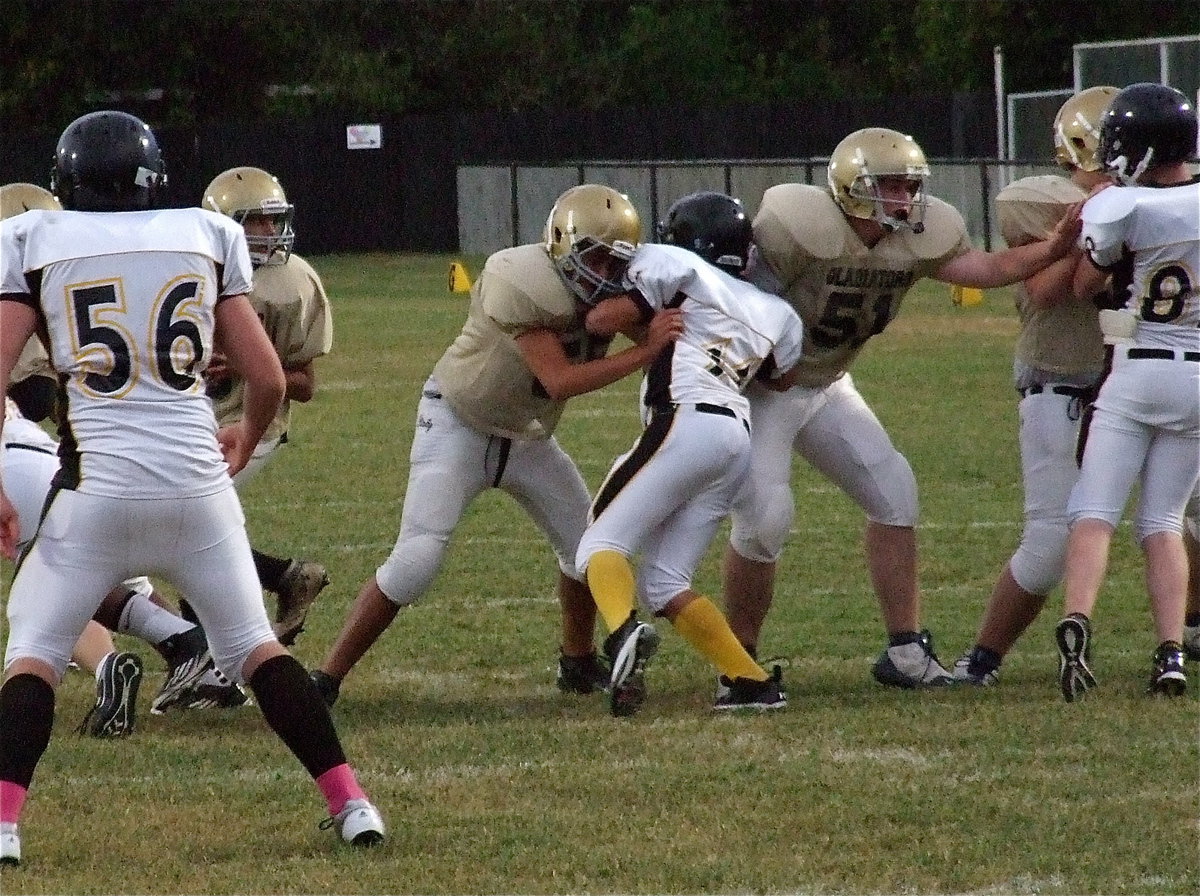 Image: David De La Hoya(55), Austin Pittmon(51) and Aaron Pittmon(50) are a wall of gold as Devonteh Williams(9) drops back, yet again, for another passing try.