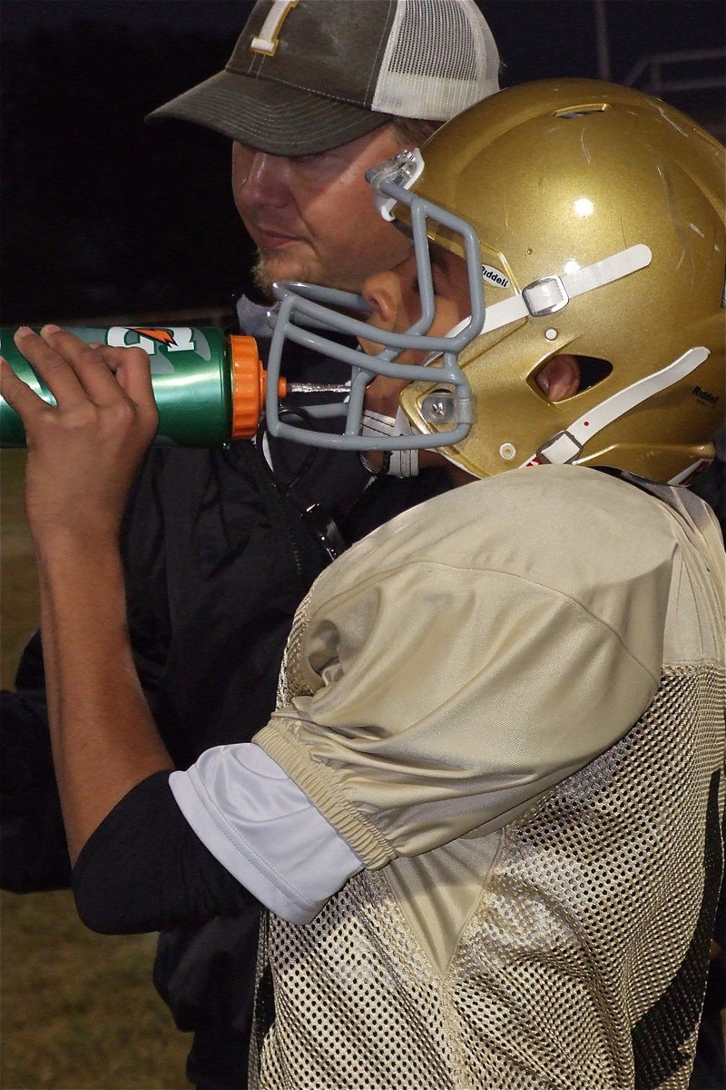 Image: Coach Josh Ward chats with Tylan Wallace(10) during a timeout.