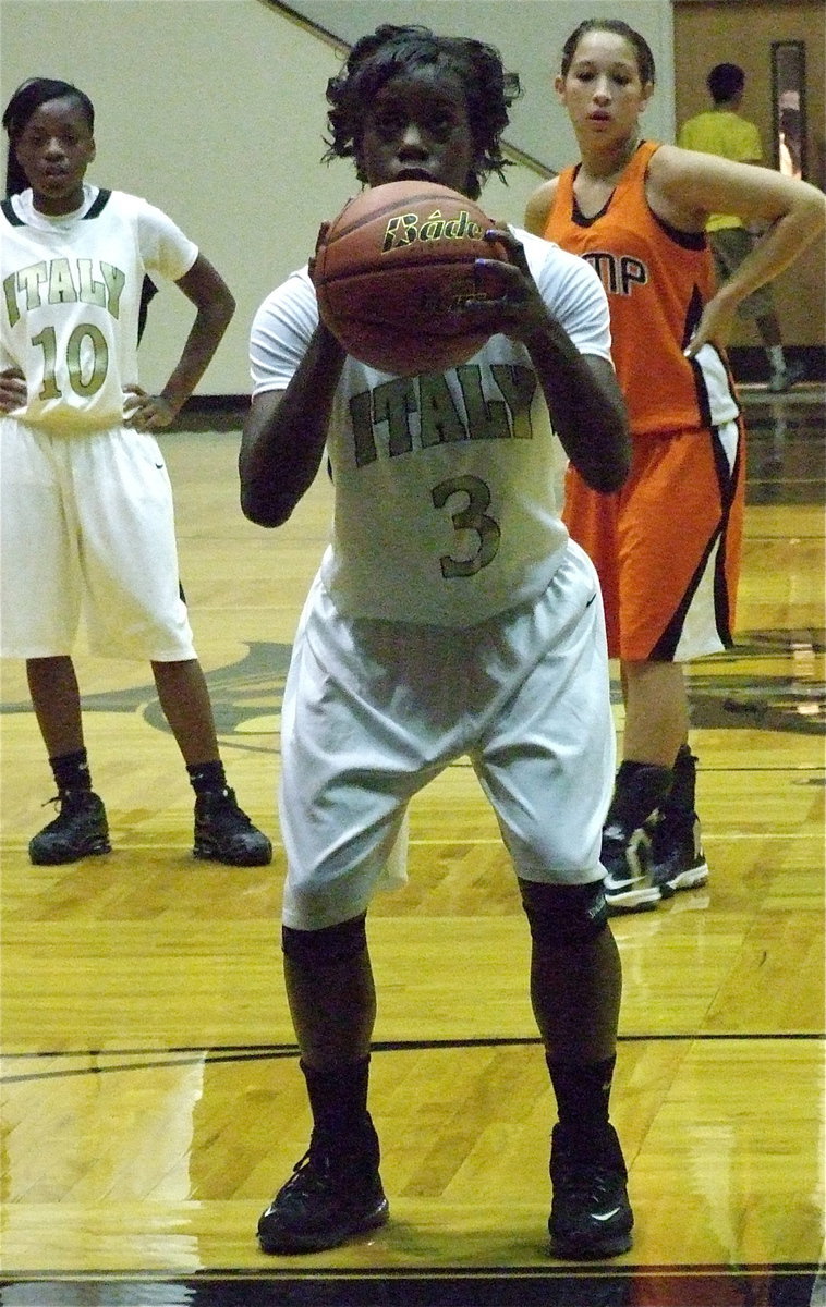 Image: Kortnei Johnson(3) steps to the line for Italy as teammate Kendra Copeland(10) looks on.