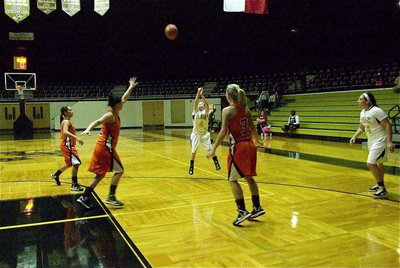 Image: Tara Wallis(4) launches a 3-pointer with Kemp’s defense sinking into the lane.