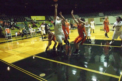 Image: Monserrat Figueroa(25) fights for the rebound and goes up quick to score a much needed basket.