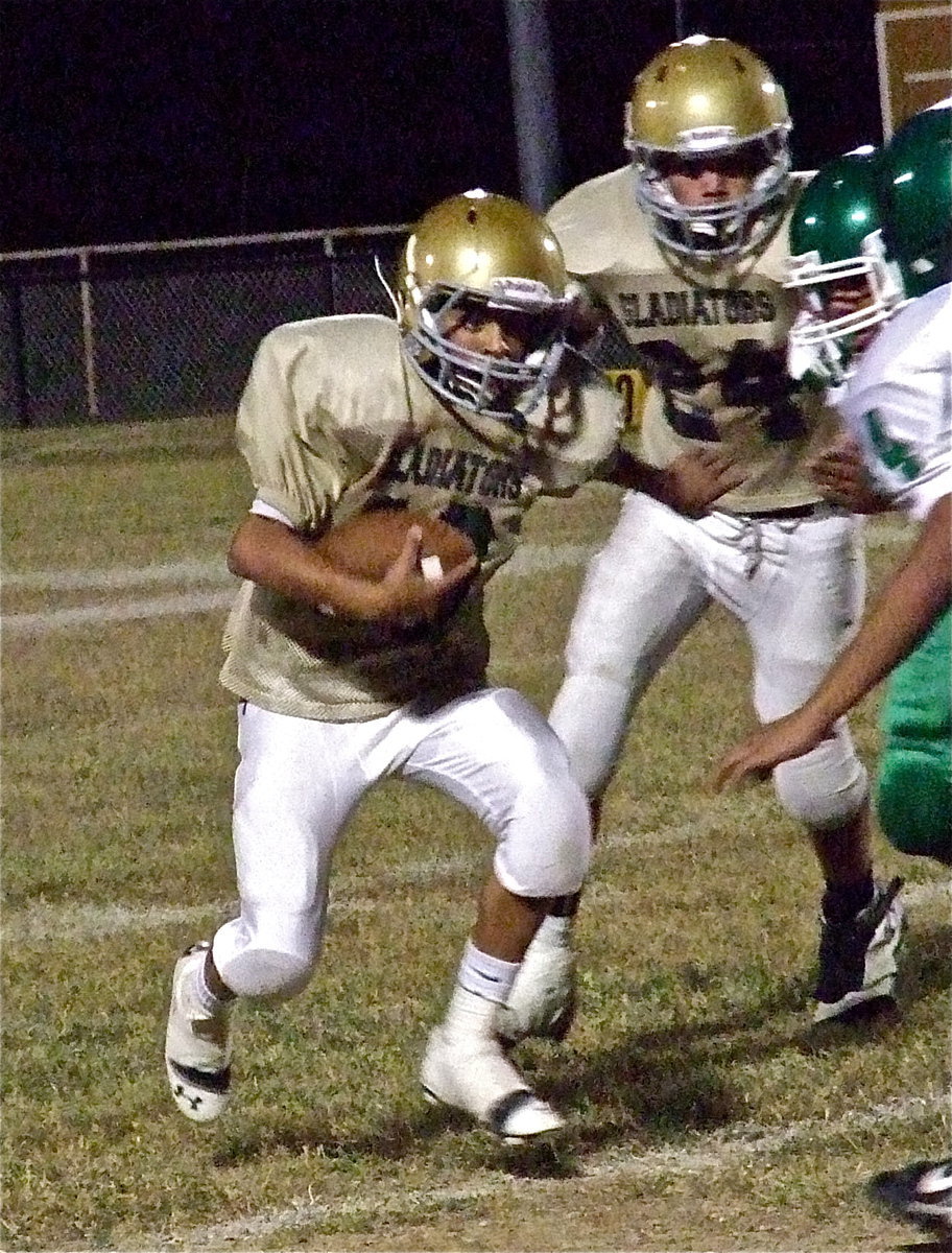 Image: Tylan Wallace(10) takes Kerens’ defenders head on with Joe Celis(24) doing what he can for his quarterback.