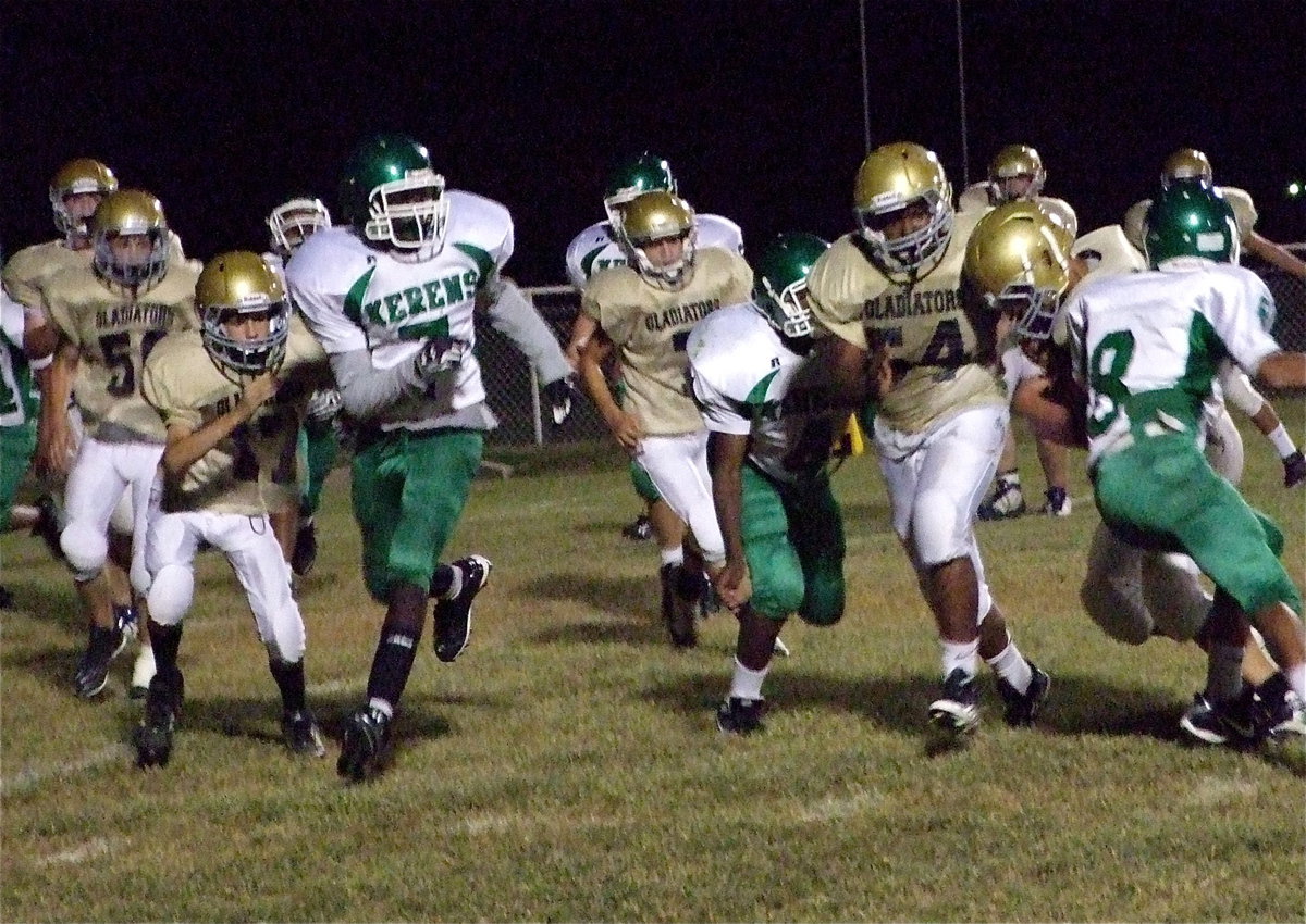 Image: Ty Hamilton(17) and Kenneth Norwood, Jr.,(54) try to get teammate Joe Celis(24) into the end zone.