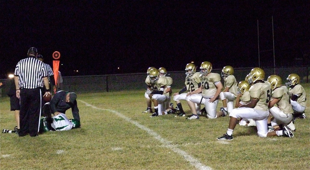 Image: The Italy defense takes a knee in a show of respect for the Bobcat that had eluded them much of the game.