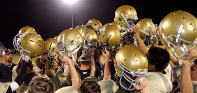 Image: Triumph! The Italy JH Gladiators raise their golden bonnets in triumph after defeating the Kerens Bobcats 38-30 while defending their home field in the team’s final game of the 2012 season.