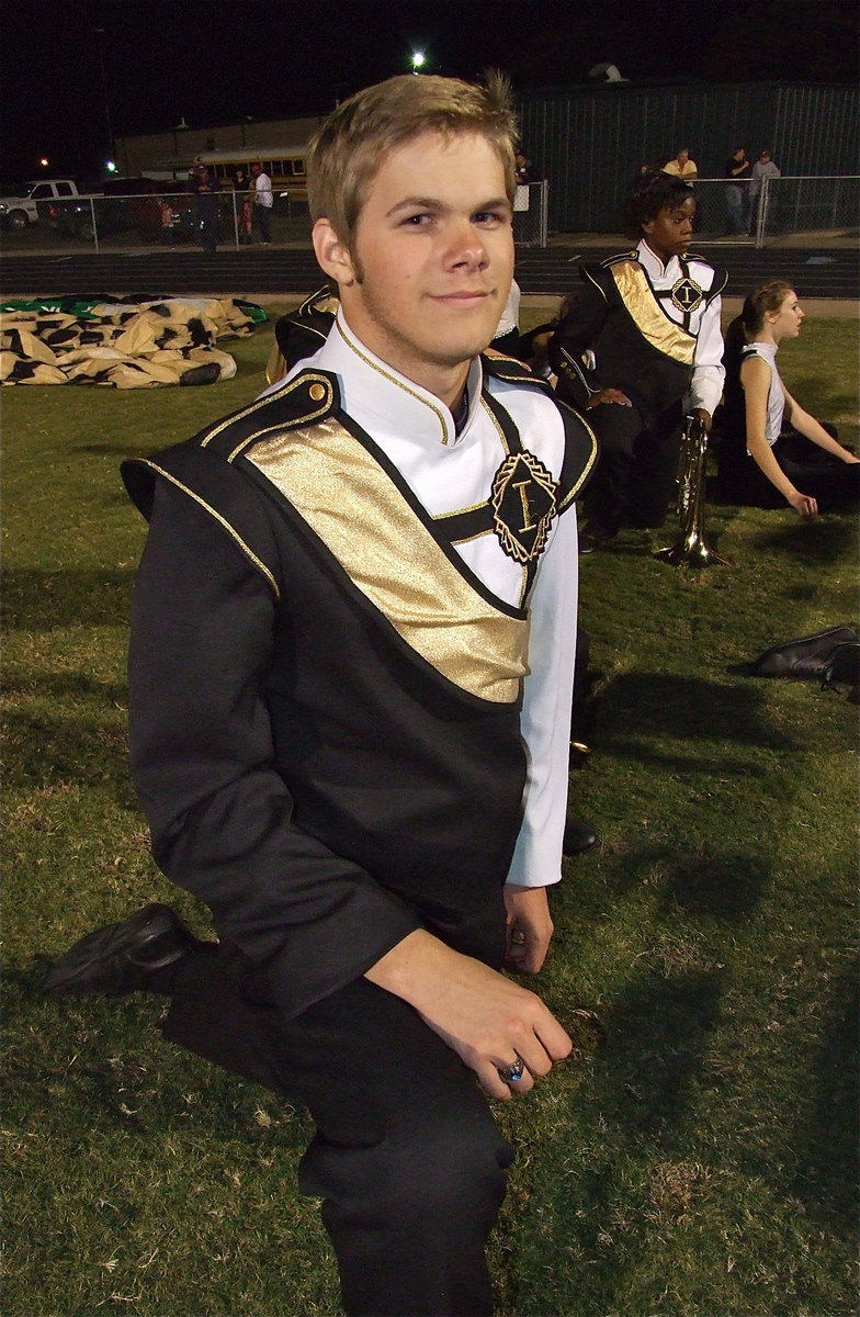 Image: Senior drumline captain Gus Allen, trumpeter Kortnei Johnson and color guard member Brooke Miller enjoy the Bobcat band’s performance.