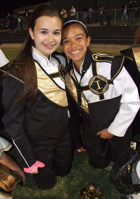 Image: Gladiator Regiment Marching Band members Amber Hooker and April Lusk team up at halftime.