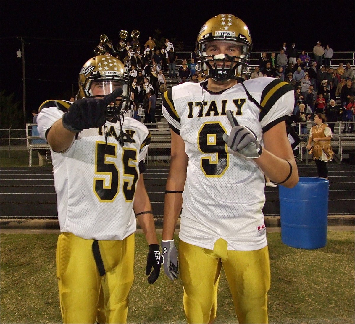 Image: Gladiator seniors Zackery Boykin(55) and Cole Hopkins(9) enjoy the support of the band and their cheerleaders as they celebrate their team’s district championship.