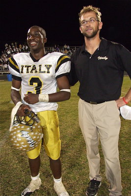 Image: Italy’s offensive coordinator Nate Skelton basks in the glow of the district championship with quarterback Marvin Cox.