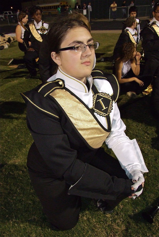 Image: Gladiator Regiment Marching Band member Morgan Junkin, a senior, is stoic during halftime as her classmates in the locker room plot a way to bring the golden football back home to Italy High School.