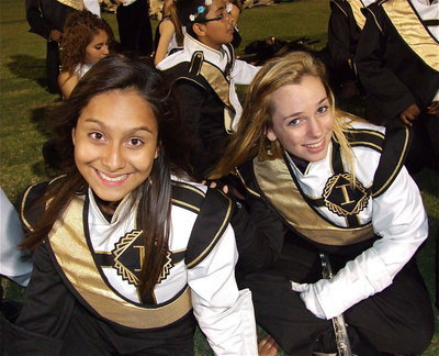Image: Gladiator Regiment Marching Band members Ana Luna and Sarah Levy relax before their halftime performance in Kerens.