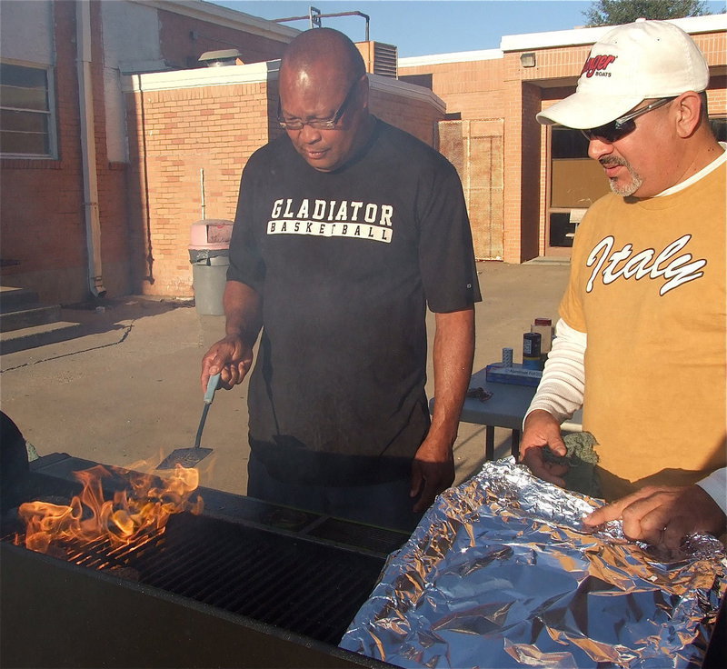Image: Gladiator assistant coach Larry Mayberry, Sr. and team dad Mark Jacinto prepare victory hamburgers for the 2012 district champion Italy Gladiators who also earned a first-round bye and the bi-distrcit championship as well after going 5-0 in district play.