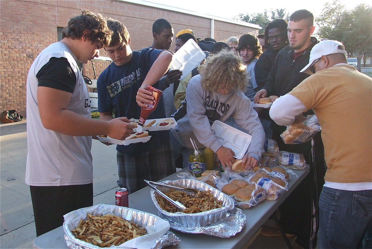 Image: Teamwork: Zain Byers squeezes ketchup for teammate Kevin Roldan as Shad Newman, Zackery Boykin, Ryheem Walker, Kyle Fortenberry and Tyvion Copeland try to make a play for the burgers.