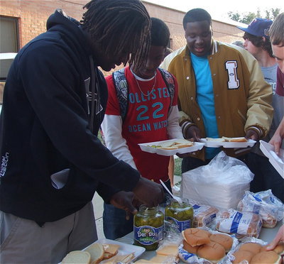 Image: Ryheem Walker, Eric Carson and Adrian Reed dig in on the chow line.