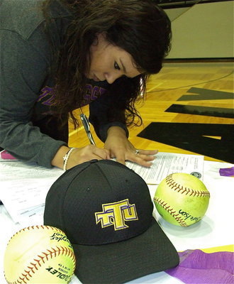 Image: Proud mom, Tina Richards, finalizes the paperwork for daughter Alyssa Richards to attend Tennessee Tech University on a softball scholarship. Alyssa follows in her sister, Megan Richards’ cleat steps who already plays softball at the collegiate level.
