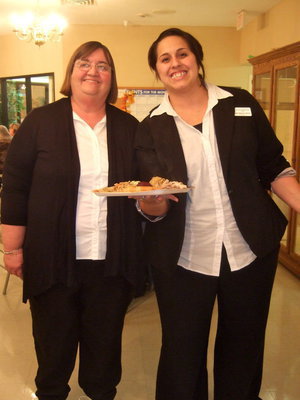 Image: Carolyn Powell and Amanda Wilsford are all decked out in black and white and ready to serve.