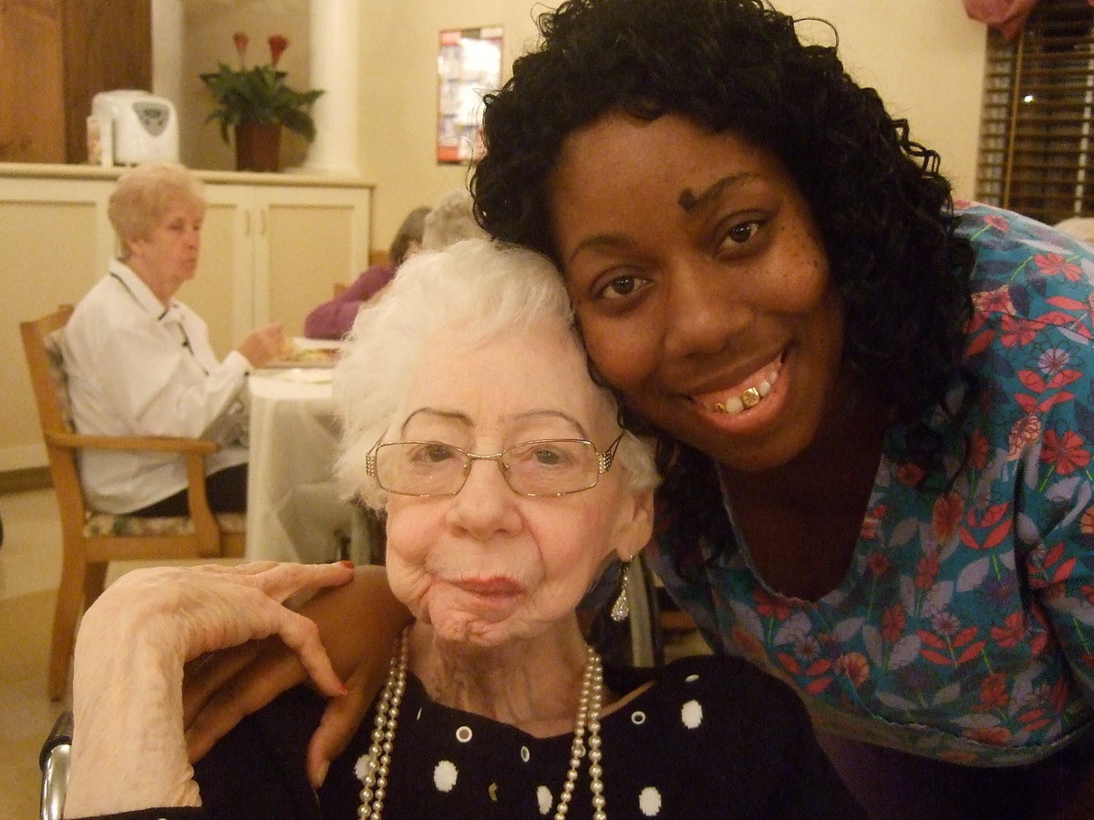 Image: Margie Saunders and Twanike Jackson share a hug and a meal.