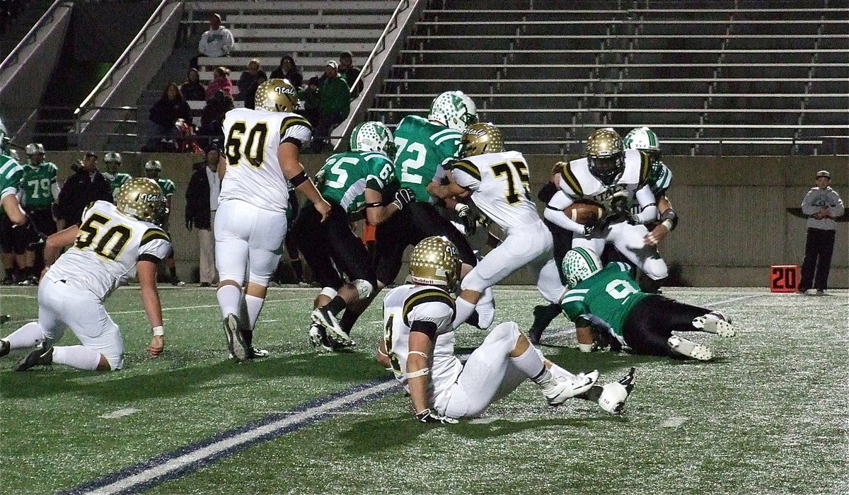 Image: Ryheem Walker(10) fights for more yards as Cody Medrano(75) keeps blocking Eagle defenders.