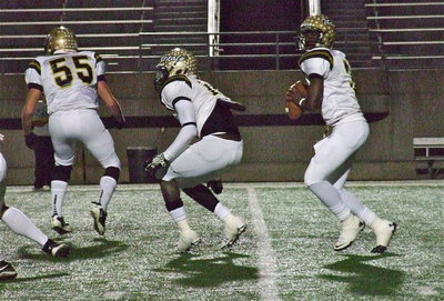 Image: Zackery Boykin(55) and Ryheem Walker(10) help create a launching pad for the rocket arm of QB Marvin Cox(3). Cox completed 7-of-12 passes for 47 yards and 1 two-point conversion pass to teammate Eric Carson(12).