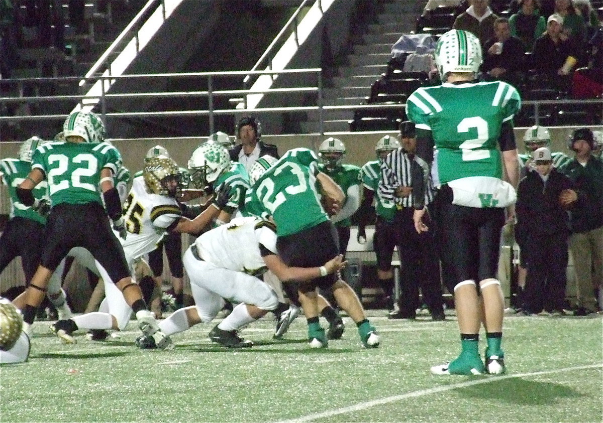 Image: Zain Byers(50) brings down Eagle back Landon Boaz(23) as Italy’s Shad Newman(25) fends off blockers.