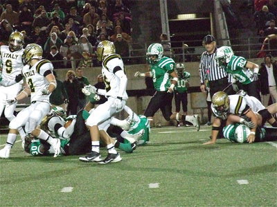 Image: Cole Hopkins(9), Chase Hamilton(2) and Levi McBride(85) lead the way for Ryheem Walker(10) who gains yards after a block by Kevin Roldan(60).