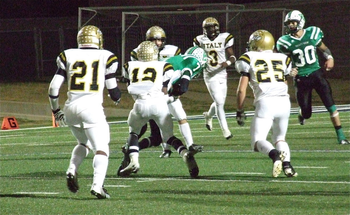 Image: Eric Carson(12) pulls down Eagle receiver Cole Seese(7) with Valley View desperately trying to reach the end zone as Italy’s Jalarnce Lewis(21), Shad Newman(25), Kyle Fortneberry(66) and Marvin Cox(3) converge on the ball. The Gladiators secure a 35-14 win to claim the area championship.