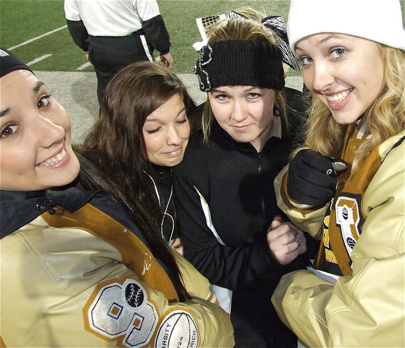 Image: Alyssa Richards, Morgan Cockerham, Taylor Turner and Jaclynn Lewis try to stay warm before the action heats up.